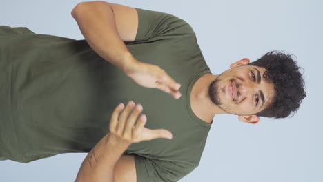Vertical-video-of-Man-clapping-excitedly-to-camera.